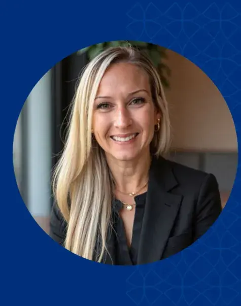 Women with blonde hair smiling and wearing a black jacket