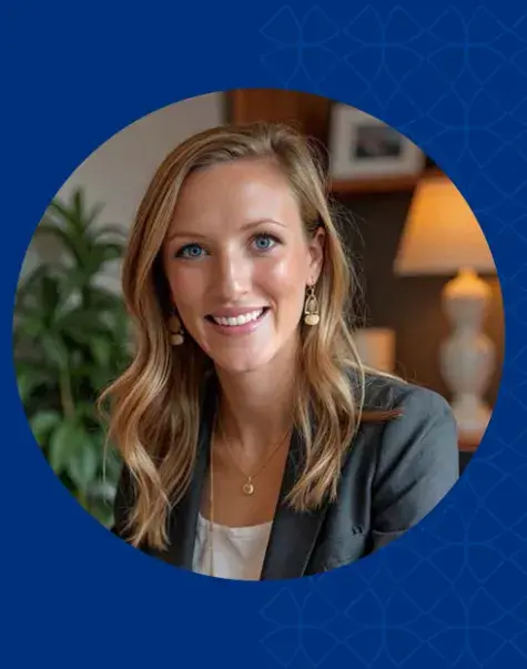 Woman with blond hair smiling and wearing gray jacket