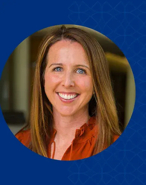 Women with dark blonde hair smiling and wearing a red shirt