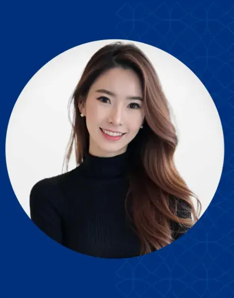 Woman with long brown hair smiling and wearing a black shirt