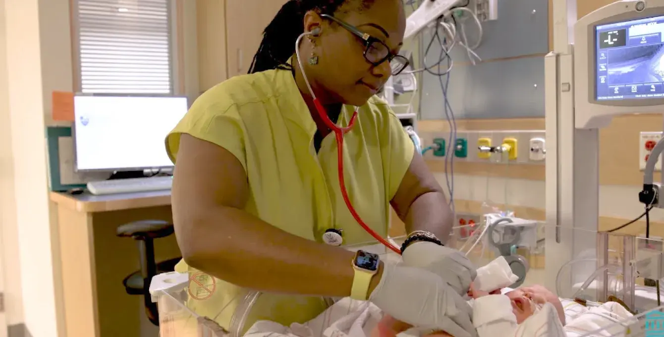 A student nurse in the MGH IHP Fast-Track BSN Program performing a newborn assessment as part of the accelerated nursing curriculum. This intensive nursing training focuses on preparing students for nursing licensure through hands-on experiences in a high-paced clinical environment.