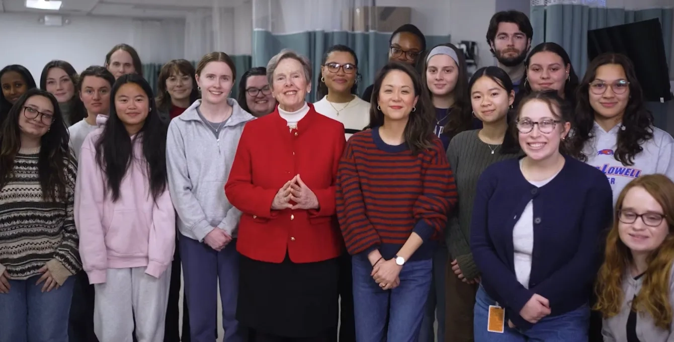Our school president stands in front of a group of health professions students 